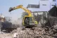 Rescuers clean debris from damaged buildings in the aftermat