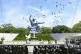 Doves fly over the Peace Statue during a ceremony to mark th