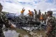 Nepal army personnel sort through the debris after a domesti