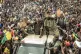 An unidentified representative of the junta waves from a mil