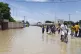 People walk through floodwaters following a dam collapse in 