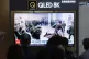 A TV screen shows an image of soldiers believed to be from N