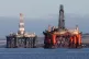 An oil platform standing amongst other rigs that have been l