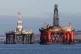 An oil platform standing amongst other rigs that have been l