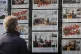 A man looks through an estate agent's window in Glasgow, Sco