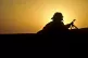 The sun rises as a soldier from the 1st Battalion Royal Regi
