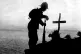 A British soldier pays his respects at the grave of a collea