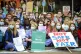 Junior doctors wear scrubs and masks as they sit down in a s
