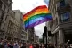 A rainbow flag is held aloft as the Pride in London parade m