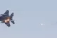 An F15 jet is seen as it flies over British Army soldiers, F