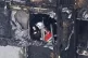 A firefighter investigates a floor after a fire engulfed the