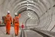 Two workers walk through a Crossrail tunnel in London