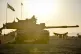 The sun sets over a Battle Tank in the Oman desert, where Br