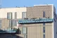 Workers apply cladding to a building in the Nottingham City 