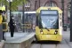 Commuters wait to board a tram in Manchester, after the Prim