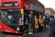 People board a bus outside Waterloo station in London