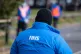 An NHS Test and Trace logo on a member of staff's jacket at 