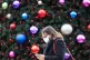 A woman walks past a Christmas tree in Trinity Leeds shoppin