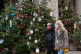 Two people wearing face masks look at a display of Christmas