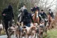 Hunt saboteurs walk with the dog pack from a Boxing Day Hunt