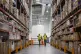 Prime Minister Boris Johnson (left) walks with warehouse sup