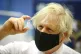 Prime minister Boris Johnson holding a vial of the Oxford/As