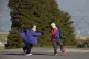 Two children play tag in the school ground of Scoil Naomh Lo