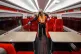 A cleaner uses a fogging machine to clean a train carriage d