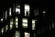 A person stands in the window of an empty office block