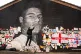 Street artist Akse P19 repairs the mural of Manchester Unite