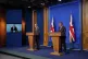 Prime Minister Boris Johnson appears on a screen as he self-