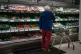 A shopper looks at salad vegetables in a branch of Waitrose 