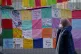 A person walks past messages left on a fence at the Scottish