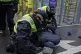 Police pin a protester to the floor after he tried to climb 