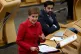 Scottish health secretary Humza Yousaf sits beside First Min