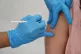 A person receiving a Covid-19 jab
