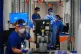 Medical staff wearing PPE work in a corridor on a ward for C