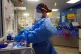A nurse puts on PPE on a ward for Covid patients at King's C