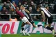 Aston Villa's Leon Bailey (left) is held by Newcastle United