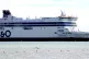 An open water swimmer swimming alongside the P&O Spirit of F
