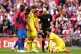 Referee Anthony Taylor (centre) shows a yellow card to Chels