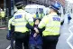 Police officers detain activists from Just Stop Oil during t