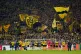 Borussia Dortmund players celebrate with fans after holding 