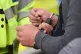 A man is handcuffed by police
