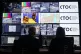 A wall of screens displaying surveillance camera footage at 
