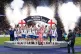 England players on the podium lift the trophy following the 