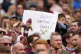 A West Ham United fan holds up a sign wishing the team good 