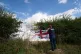 An idiot hangs a St George Cross flag with the words ‘Refu