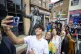People pose for a selfi with the newly unveiled statue of an