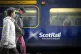 Commuters walking past a ScotRail train at Edinburgh's Waver